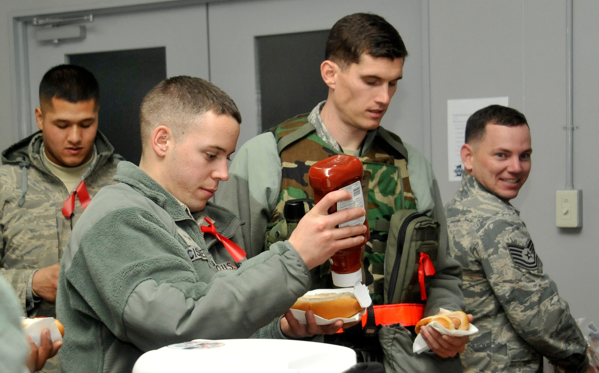 Airmen from the 35th Aircraft Maintenance Squadron and 35th Maintenance Squadron grab refreshments in the departure lobby of the passenger terminal before simulating their departure from Misawa Air Base, Japan, Jan. 10, 2013. Airmen simulated deploying to test the wing’s ability to go from peacetime readiness to wartime operations during an Initial Response Readiness Exercise. (U.S. Air Force photo by Airman 1st Class Zachary Kee) 