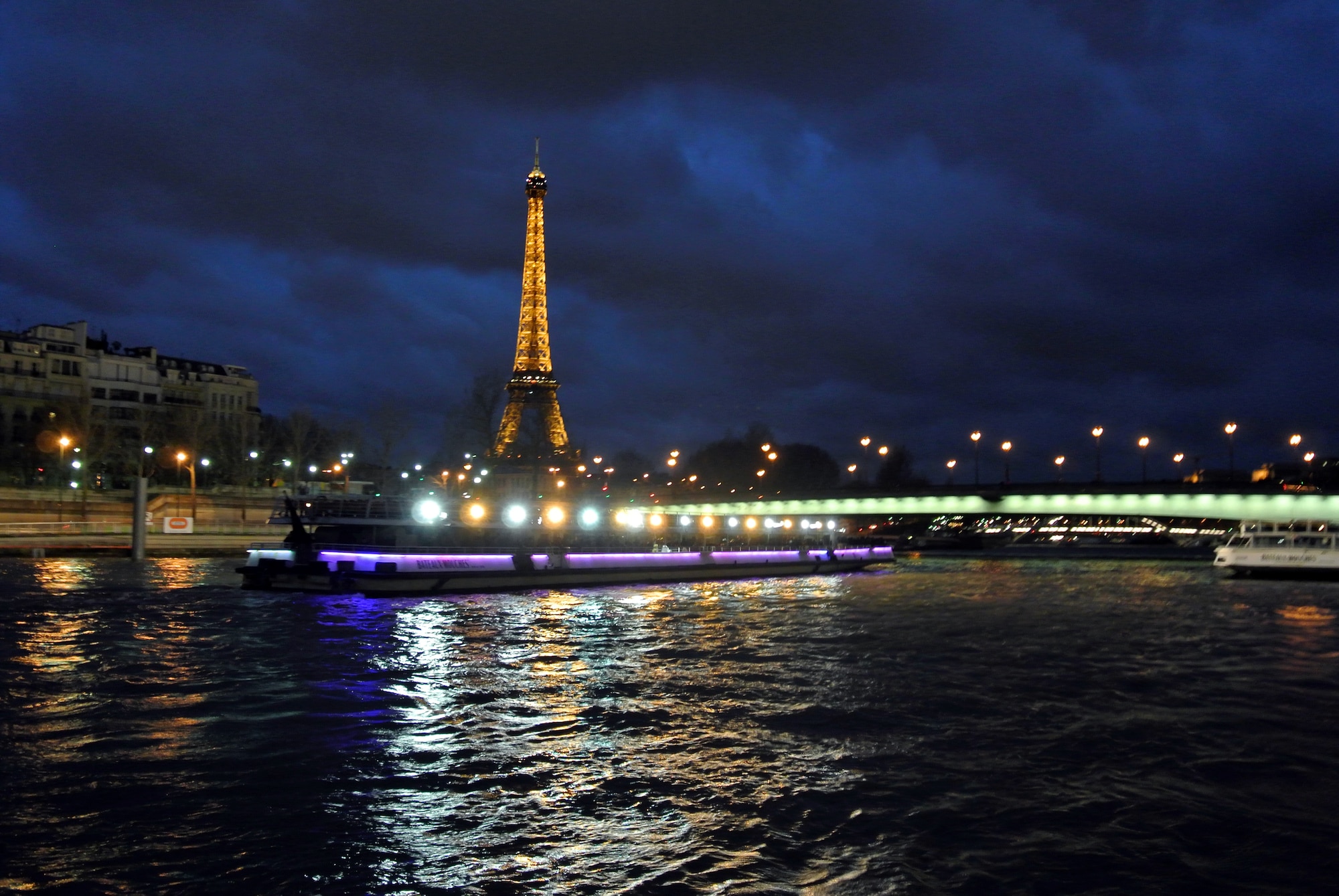 The Eiffel tower illuminates the skyline during a boat tour of the City of Light. The Eiffel tower was constructed in 1889 and is one of the most recognized and photographed structures in the world. (U.S. Air Force photo/Senior Airman Michael Battles)