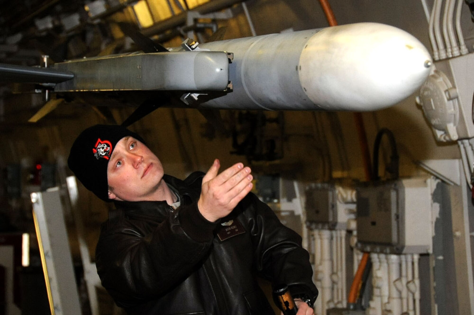 U.S. Air Force Capt. Jason Holmes, 13th Fighter Squadron assistant chief of standardization and evaluation, inspects an F-16 Fighting Falcon during an Initial Readiness Response Exercise at Misawa Air Base, Japan, 11, 2013. During the inspection, Holmes looked for anything that is missing or improperly installed on the missile. The base is preparing for a real-world training exercise in conjunction with the IRRE.  (U.S. Air Force photo by Airman 1st Class Kenna Jackson)