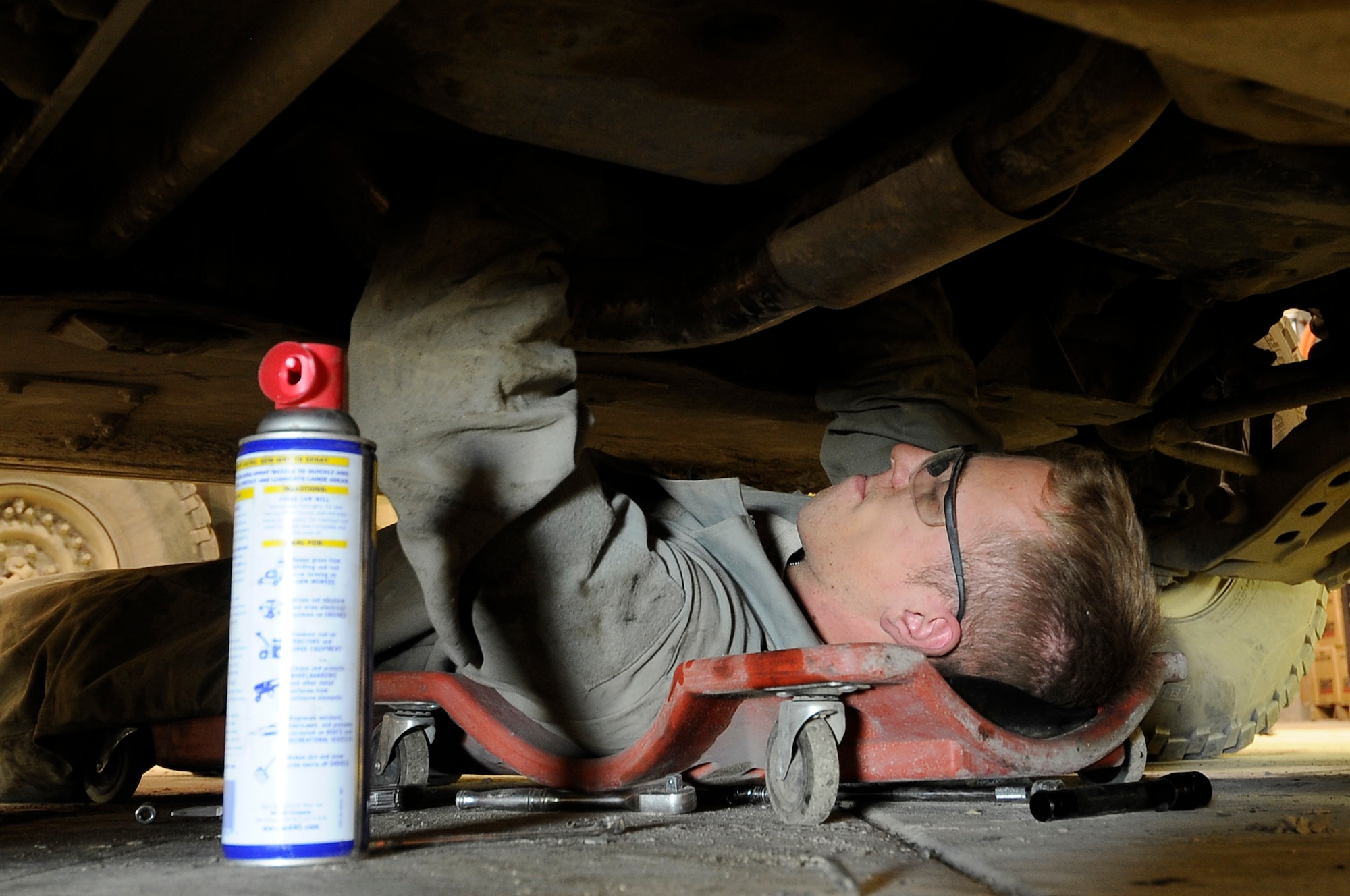Tech. Sgt. Steven Esworthy-Jones, 455th Logistic Readiness Group tactical vehicle mechanic,fixes a transmission shift linkage on an armored humvee on Bagram Airfield, Jan. 9, 2013. The tactical vehicle shop is responsible for maintaining weapon systems vehicles. (U.S. Air Force Photo/Master Sgt. Jun Kim)