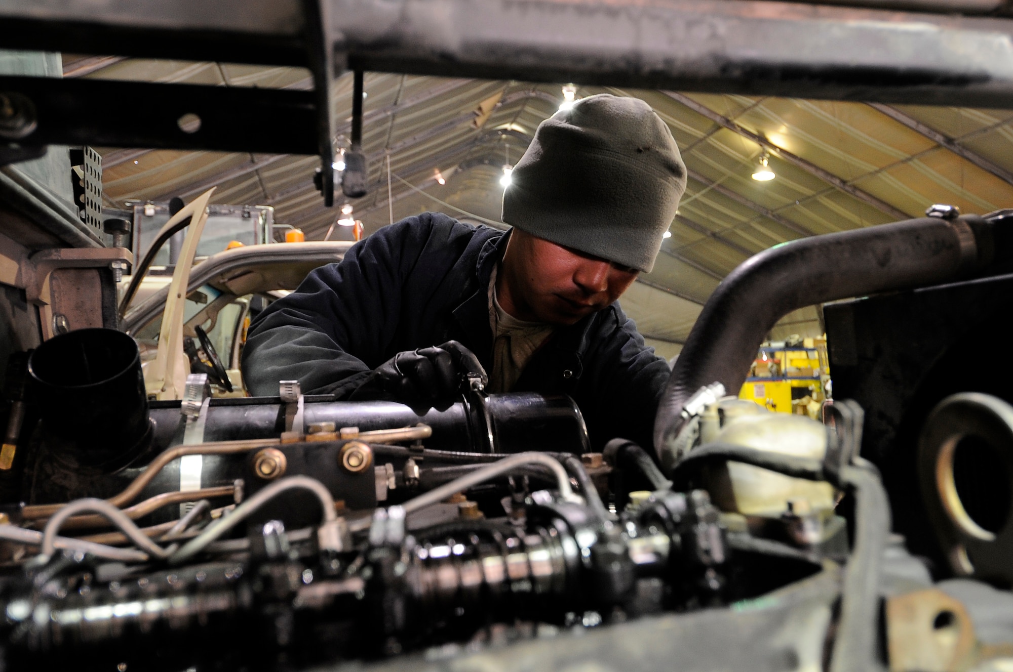 Senior Airman Richard Igid, 455th Logistic Readiness Group vehicle mechanic, installs a new fuel pump on a forklift on Bagram Airfield, Jan. 9, 2013. The 455th ELRS vehicle maintenance shop performs major maintenance on more than 1,000 base vehicles. (U.S. Air Force Photo/Master Sgt. Jun Kim)