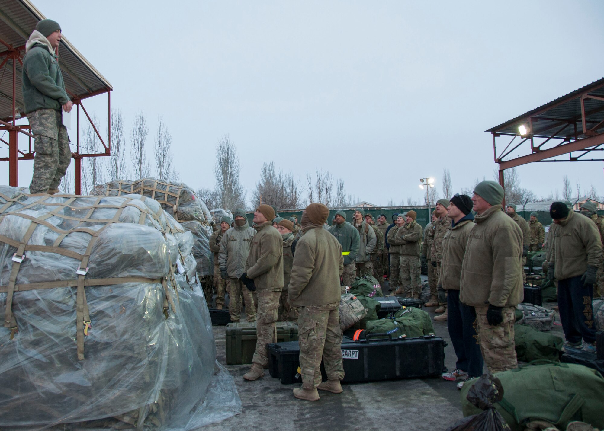 A U.S. Army customs border agent briefs a group of redeployers on the customs process for returning to the U.S. at Transit Center at Manas, Kyrgyzstan, Jan. 3, 2013. While the Transit Center has historically provided the onward movement for Soldiers, Airmen and Marines returning from Afghanistan, the Navy only recently began redeploying Sailors through here. (U.S. Air Force photo/Tech. Sgt. Rachel Martinez)