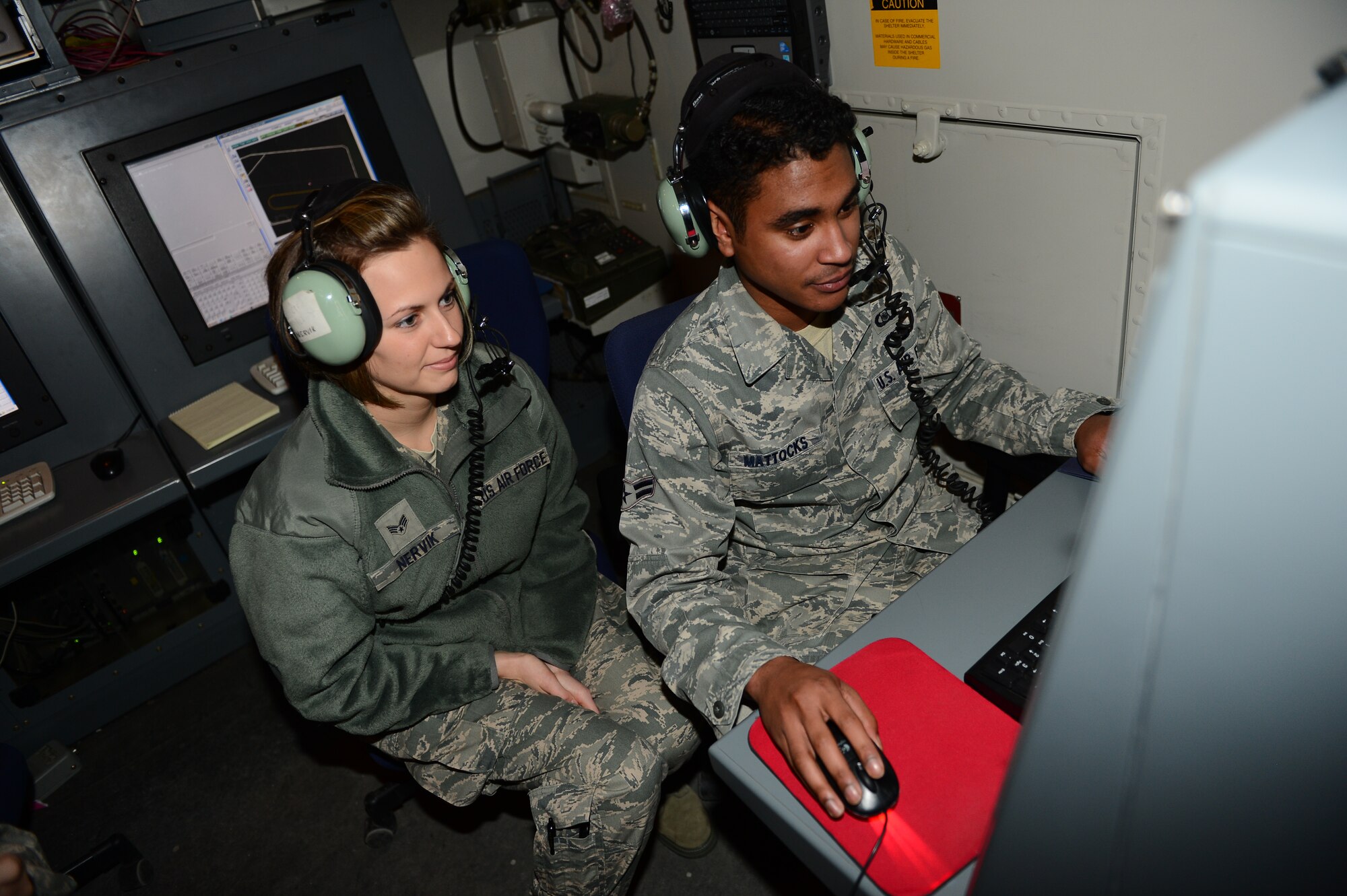 SPANGDAHLEM AIR BASE, Germany – U.S. Air Force Senior Airman Caitlin Nervik, left, from Milford, N.H., and U.S. Air Force Airman 1st Class Vicente Mattocks, from San Diego, 606th Air Control Squadron command and control battle management operators, control aerospace assets using ground radar, Jan. 8, 2013. These operators are responsible for controlling U.S. and allied aircraft during Red Flag 13-2 and other combat training scenarios. (U.S. Air Force photo by Airman 1st Class Dillon Davis/Released)
