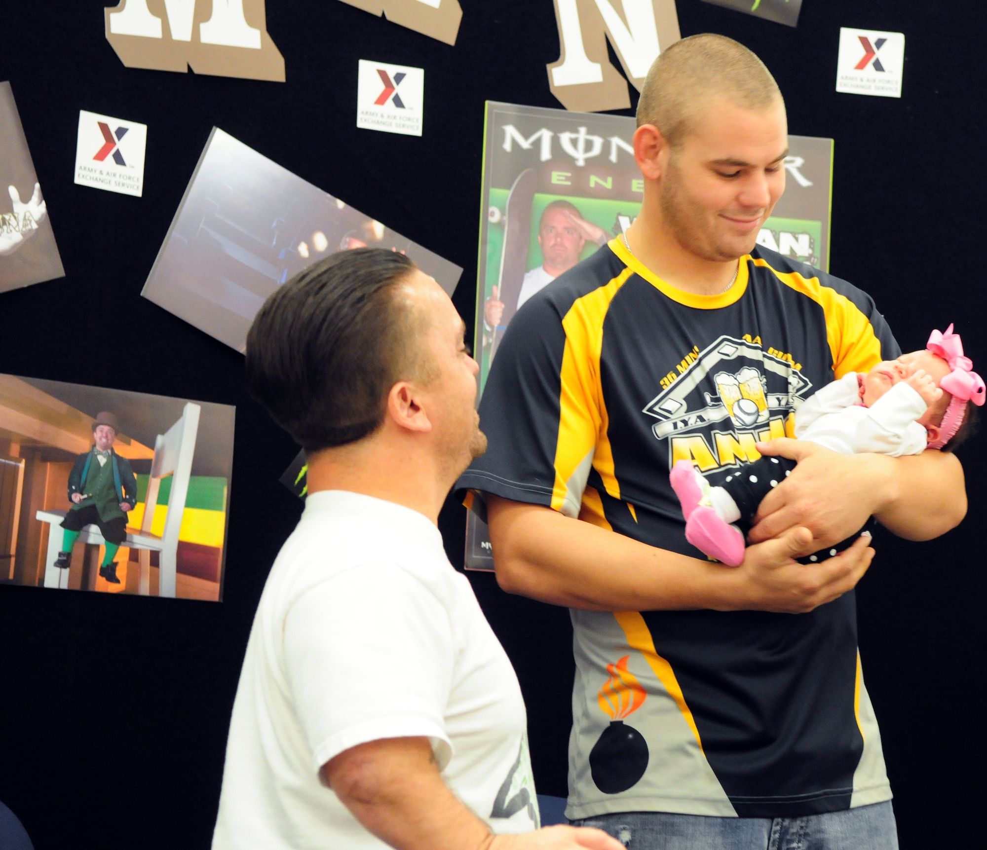 Actor Jason “Wee Man” Acuña greets Senior Airman Cody Allen, 36th Munitions Squadron, and his three-week old daughter, Callea, at the Base Exchange on Andersen Air Force Base, Guam, Jan. 9. Wee Man Signed autographs, raffled prizes, conducted a skateboard demonstration and previewed his newest movie for Airmen and family members at Andersen as part of his Wee Man Salutes the Service tour. (U.S. Air Force photo by Senior Airman Robert Hicks/Released)