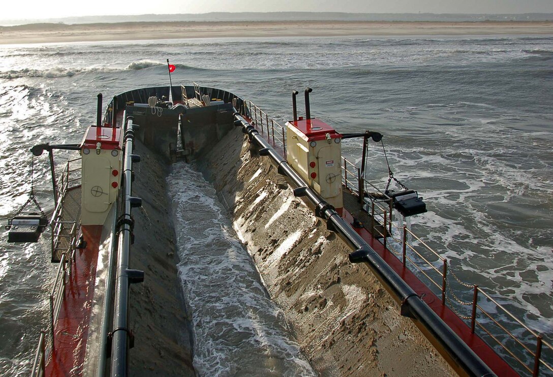 The Wilmington District's special purpose vessel CURRITUCK takes a full load of material dredged from the harbor at Ocean City, Maryland to the shore of Assateague Island.  The CURRITUCK's shallow draft capabilities allow it to unload material in six of water.  This creates a more natural look along the shoreline and helps to reduce erosion.  (USACE photo by Hank Heusinkveld)