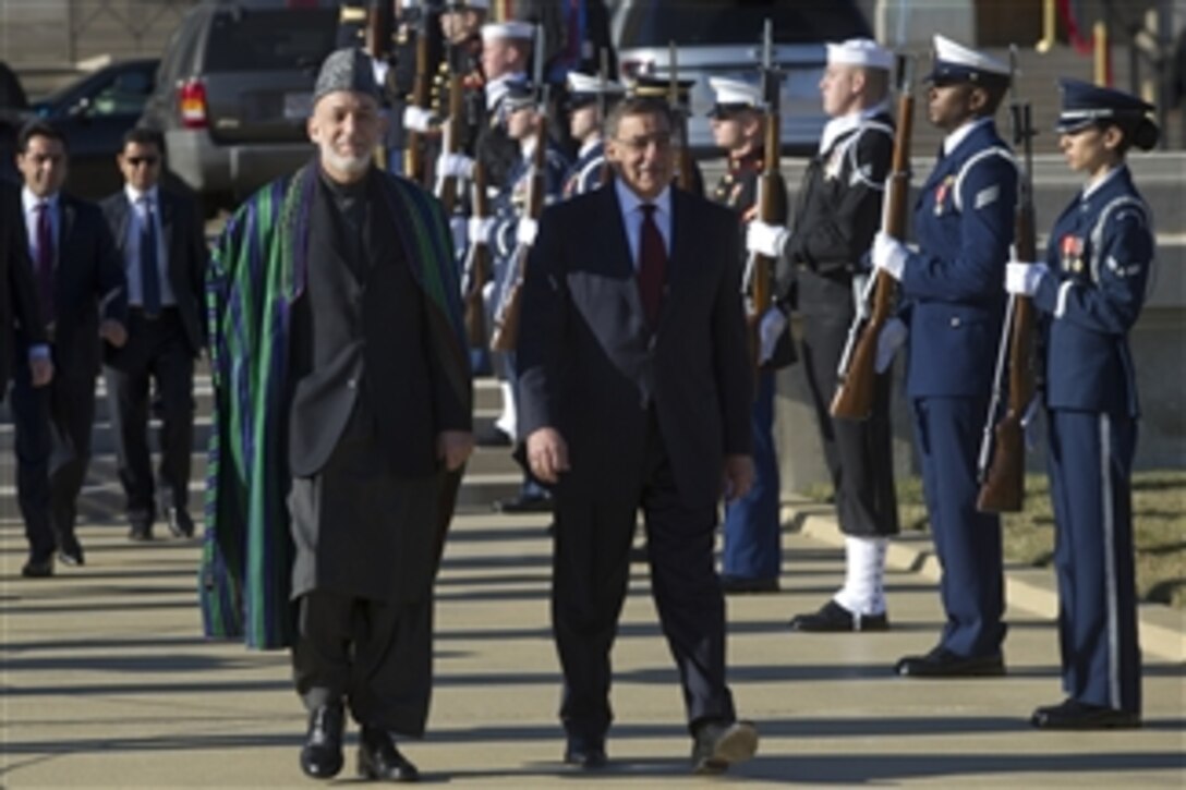 Secretary of Defense Leon E. Panetta, right, escorts Afghanistan's President Hamid Karzai to a full honors arrival ceremony to welcome Karzai to the Pentagon on Jan. 10, 2013.  Panetta, Karzai and their senior advisors will meet to discuss national security items of interest to both nations.  