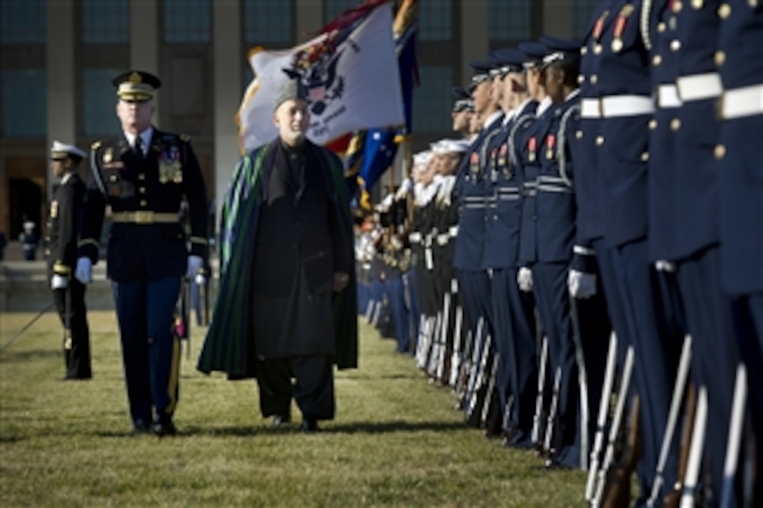 U.S. Army Col. James Markert escorts Afghanistan's President Hamid Karzai as he inspects the troops in formation on the Pentagon River Parade Field on Jan. 10, 2013.  
Secretary of Defense Leon E. Panetta is hosting the full honors arrival ceremony to welcome Karzai to the Pentagon.  Panetta, Karzai and their senior advisors will meet to discuss national security items of interest to both nations. 