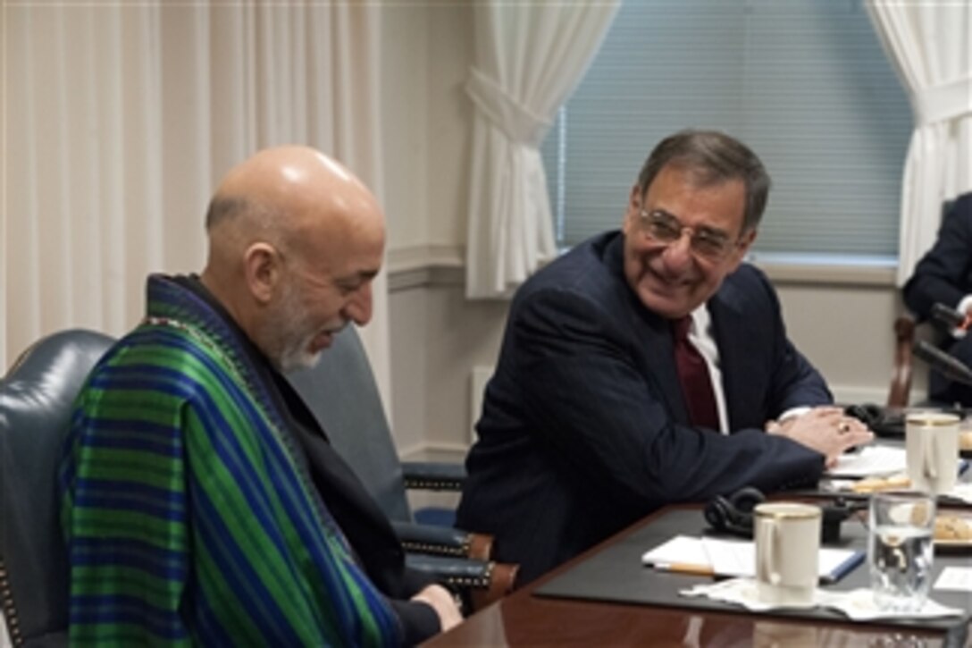 Secretary of Defense Leon E. Panetta, right, and Afghanistan's President Hamid share a private moment while waiting for their meetings to begin in the Pentagon on Jan. 10, 2013.  Panetta, Karzai and their senior advisors are meeting to discuss national security items of interest to both nations.  