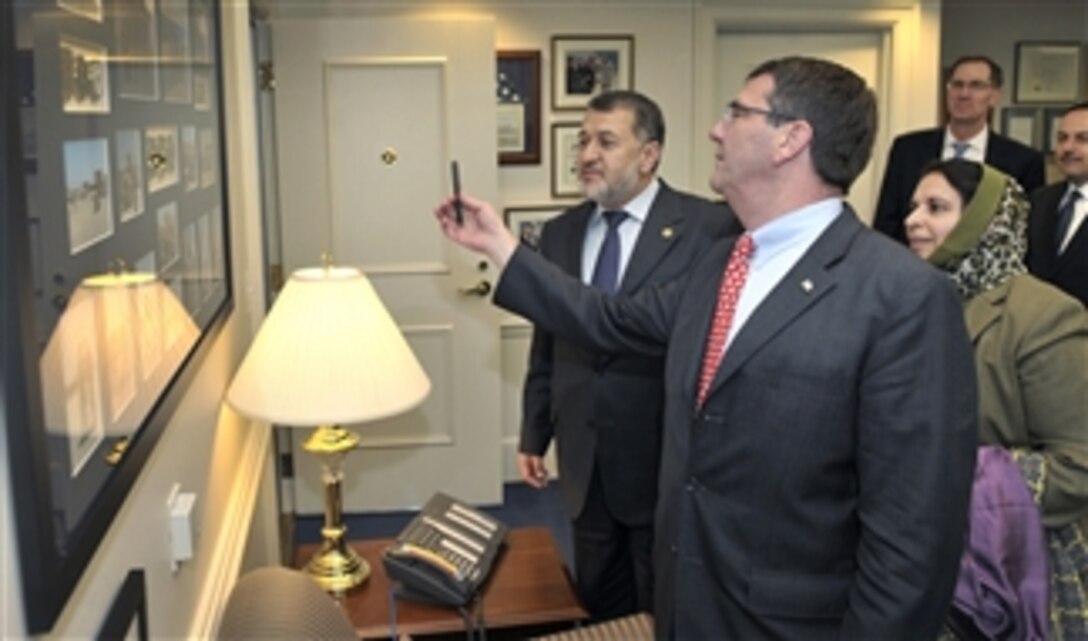 Deputy Secretary of Defense Ashton B. Carter, right, describes photographs on his wall to Afghanistan’s Minister of Defense Bismullah Muhammadi, left, prior to their meeting in the Pentagon on Jan. 9, 2013.  Carter, Bismullah and their senior advisors are meeting to discuss national security items of interest to both nations.  