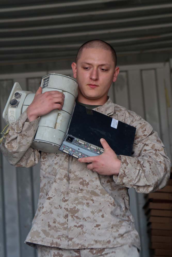 Lance Cpl. Matthew Esquivel, theater provided equipment chief with I Marine Expeditionary Force Headquarters Group (Forward), carries equipment out of a container during the retrograde process on Camp Leatherneck, Afghanistan, Jan. 9, 2013. As a lance corporal, Esquivel managed a sergeantâ€™s billet with more than 60 consolidated memorandum receipts.