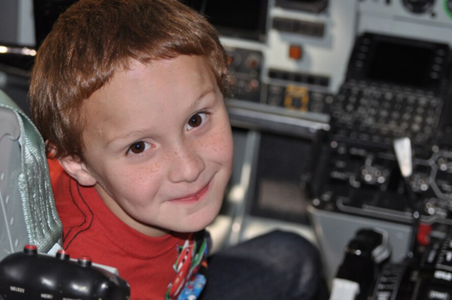 Benjamin, a special tour participant here in January, beams while sitting in the cockpit of a KC-135R Stratotanker. (USAF photo by Maj. Shsnnon Mann, 916ARW/PA)