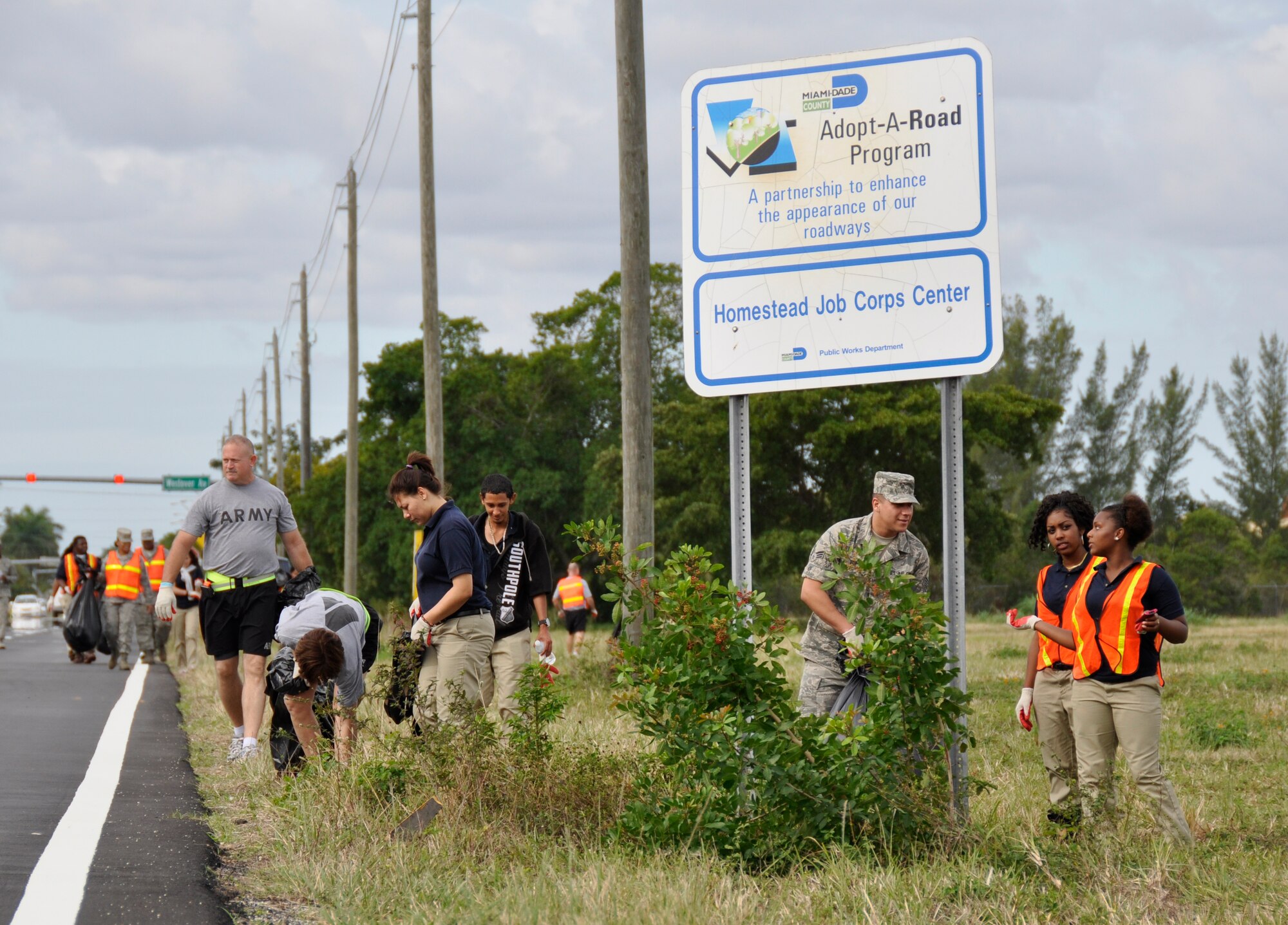 Airmen and servicemembers from Homestead Air Reserve Base, Fla., along with students of Homestead Job Corps, cleaned up roadside trash along 10 blocks of South West 288th St. in support of Adopt-A-Highway in Homestead, Fla., recently. The base has partnered with Job Corps on multiple occasions to provide outreach to the area. (U.S. Air Force photo/Senior Airman Jacob Jimenez)