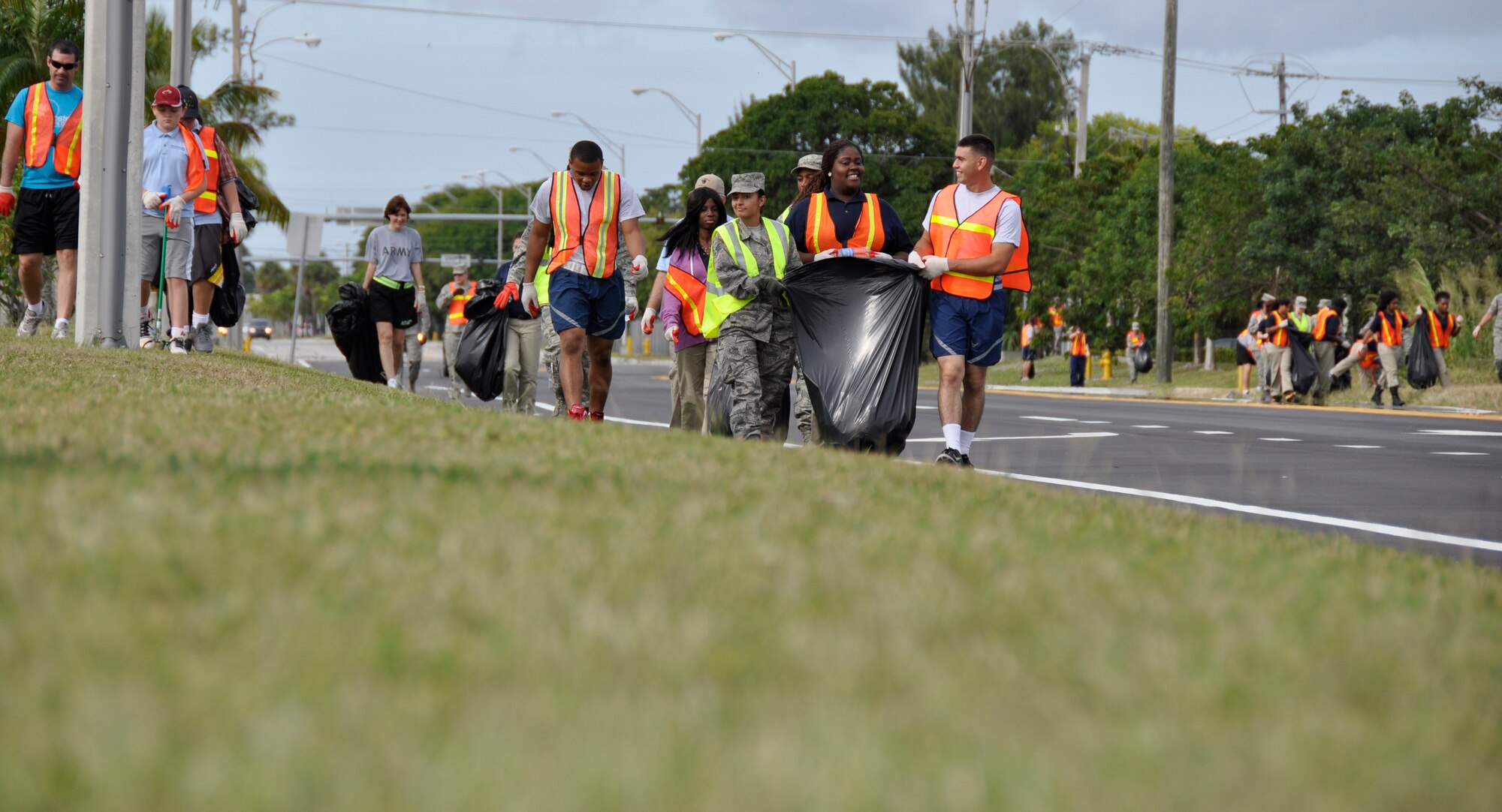 Airmen and servicemembers from Homestead Air Reserve Base, Fla., along with students of Homestead Job Corps, cleaned up roadside trash along 10 blocks of South West 288th St. in support of Adopt-A-Highway in Homestead, Fla., recently. The base has partnered with Job Corps on multiple occasions to provide outreach to the area. (U.S. Air Force photo/Senior Airman Jacob Jimenez)