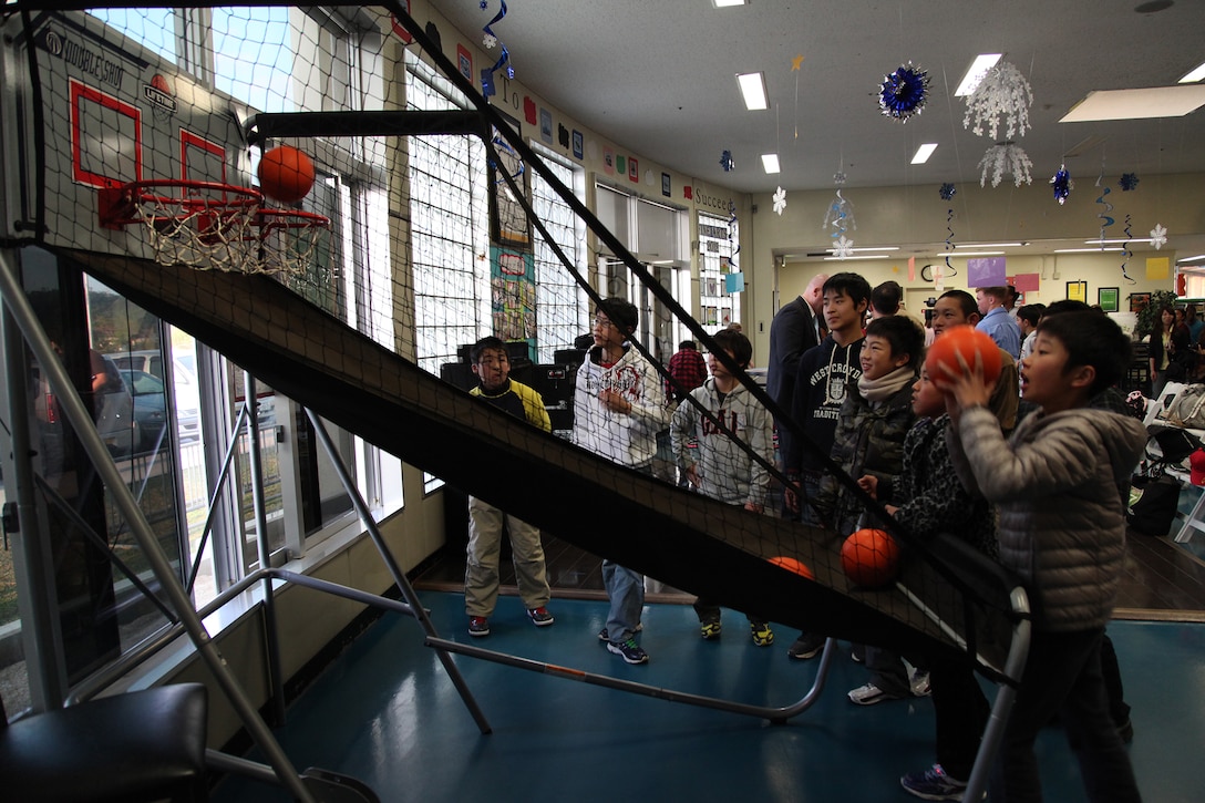 Students from Oshima elementary and middle schools play basketball Jan. 11 at the Camp Foster Youth Center. Twenty-four students from Oshima are visiting Okinawa as part of a four-day youth cultural exchange and homestay program. This is the second year of the program, which will provide both the Japanese and American children time to have fun together and learn from each other. (U.S. Marine Corps photo by /Released)