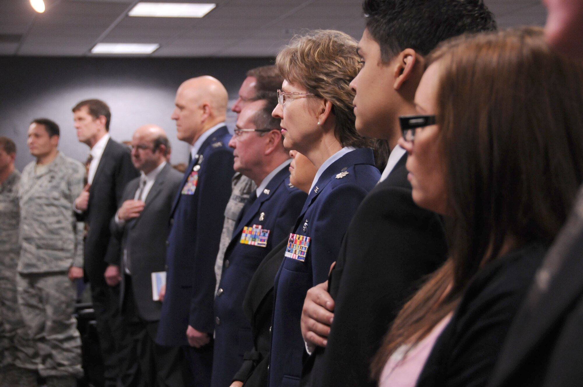 JOINT BASE ELMENDORF-RICHARDSON --  176 Wing members and family stood for the national anthem during a combined change-of-command and retirement ceremony. Lt. Col. Sharolyn Lange assumed command as Col. Ronald Kichura retired. National Guard photo by Tech. Sgt. Jennifer Theulen.