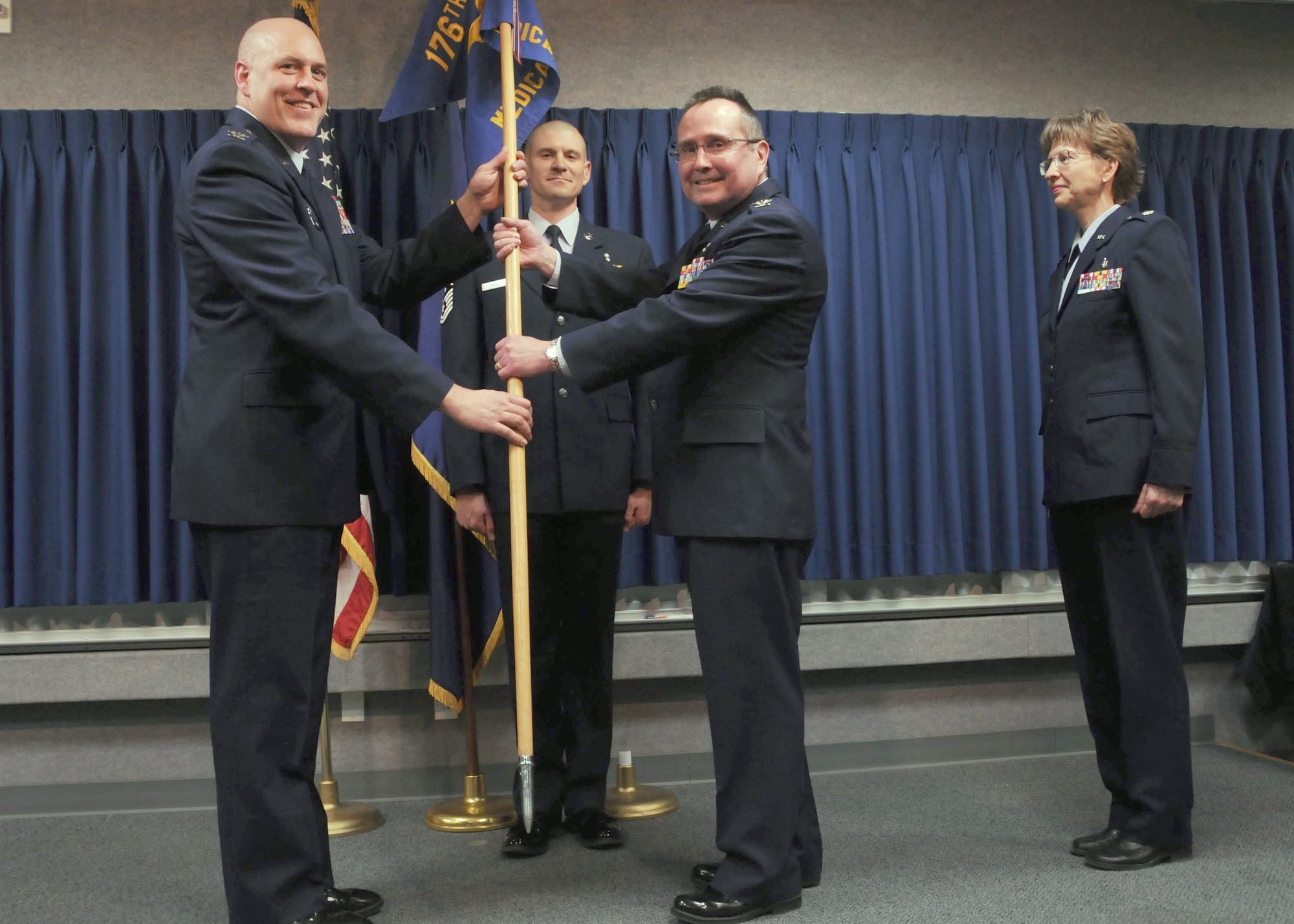 JOINT BASE ELMENDORF-RICHARDSON -- Col. Ronald Kichura relinquishes the 176 Medical Group flag during a change-of-command ceremony here Jan. 12, 2013. Lt. Col. Sharolyn Lange assumed command. National Guard photo by Tech. Sgt. Jennifer Theulen.