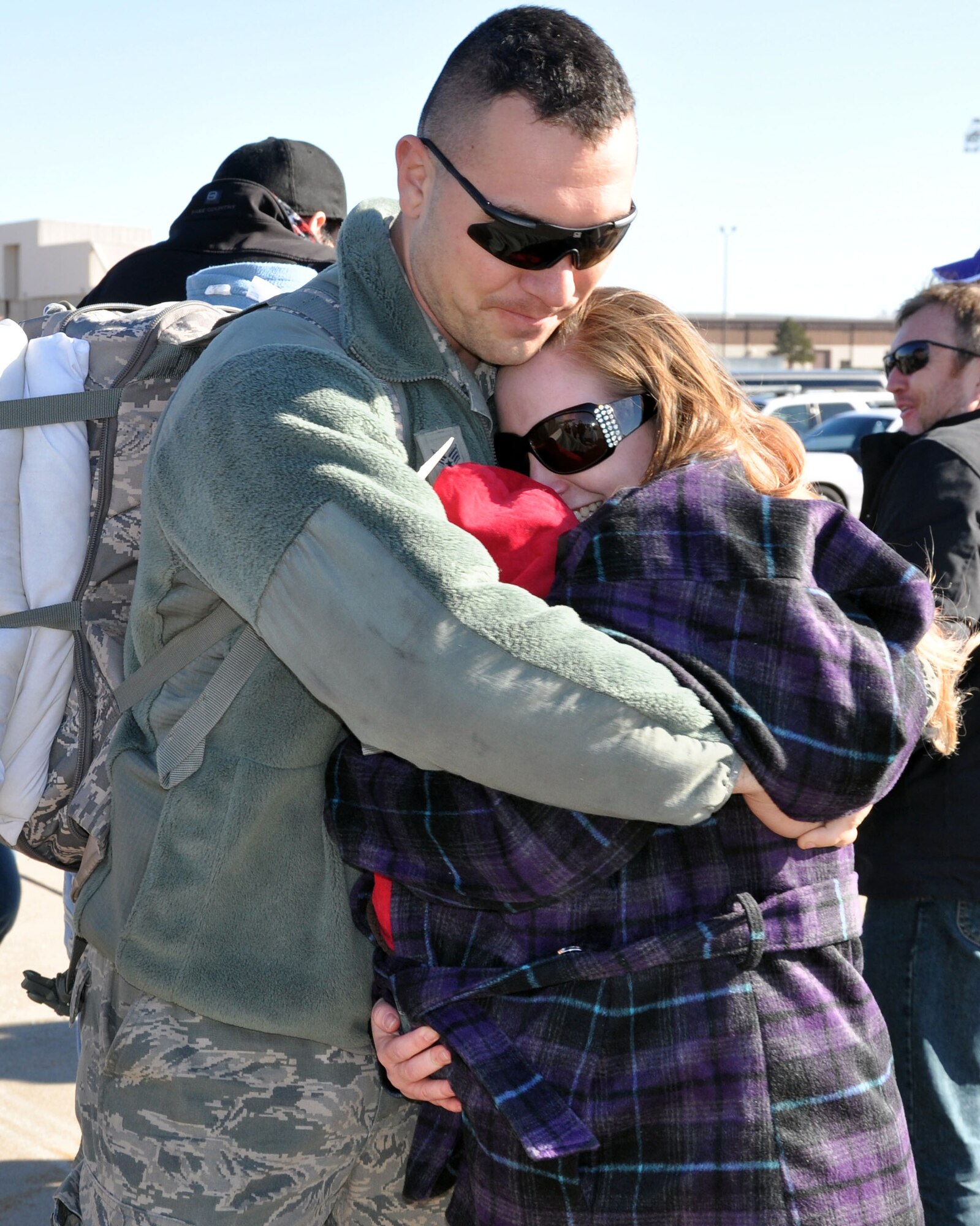Senior Airman William Huff, a member of the 931st Aircraft Maintenance Squadron, hugs his family on the flightline at McConnell Air Force Base, Kan., Jan. 13, 2013.  Huff had just returned from a deployment to Southwest Asia.  (U.S. Air Force photo by 1st Lt. Zach Anderson)