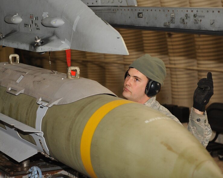 Staff Sgt. John Reams, 8th Aircraft Maintenance Squadron, ensures a bomb is aligned properly while loading an F-16 Fighting Falcon at Kunsan Air Base, Republic of Korea, Jan. 14, 2013. This was part of Beverly Midnight 13-1, an exercise which tests the capabilities and readiness of Kunsan personnel. (U.S. Air Force photo by Staff Sgt. Jonathan Fowler/Released)