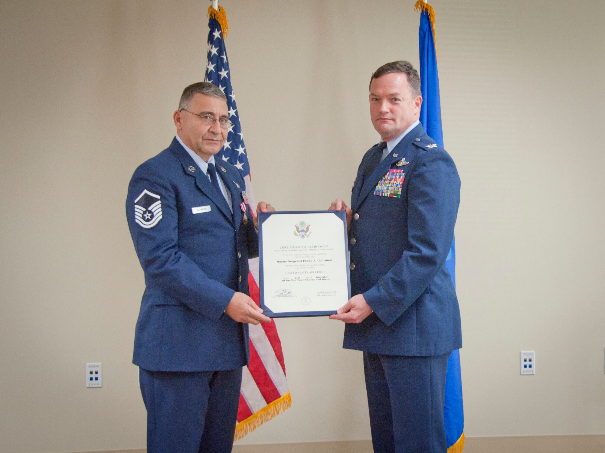 MACDILL AIR FORCE BASE, Fla. – Master Sgt. Frank Guarnieri, left, a member of the command post here, and Col. Dave Pavey, right, commander of the 927th Air Refueling Wing, hold Guarnieri’s retirememnt certificate during a ceremony here Jan. 10, 2013. Guarnieri’s 37 years of service as an Army infantry officer and Airman came to a close after a long career.  (Official U.S. Air Force photo/Staff Sgt. Shawn Rhodes)