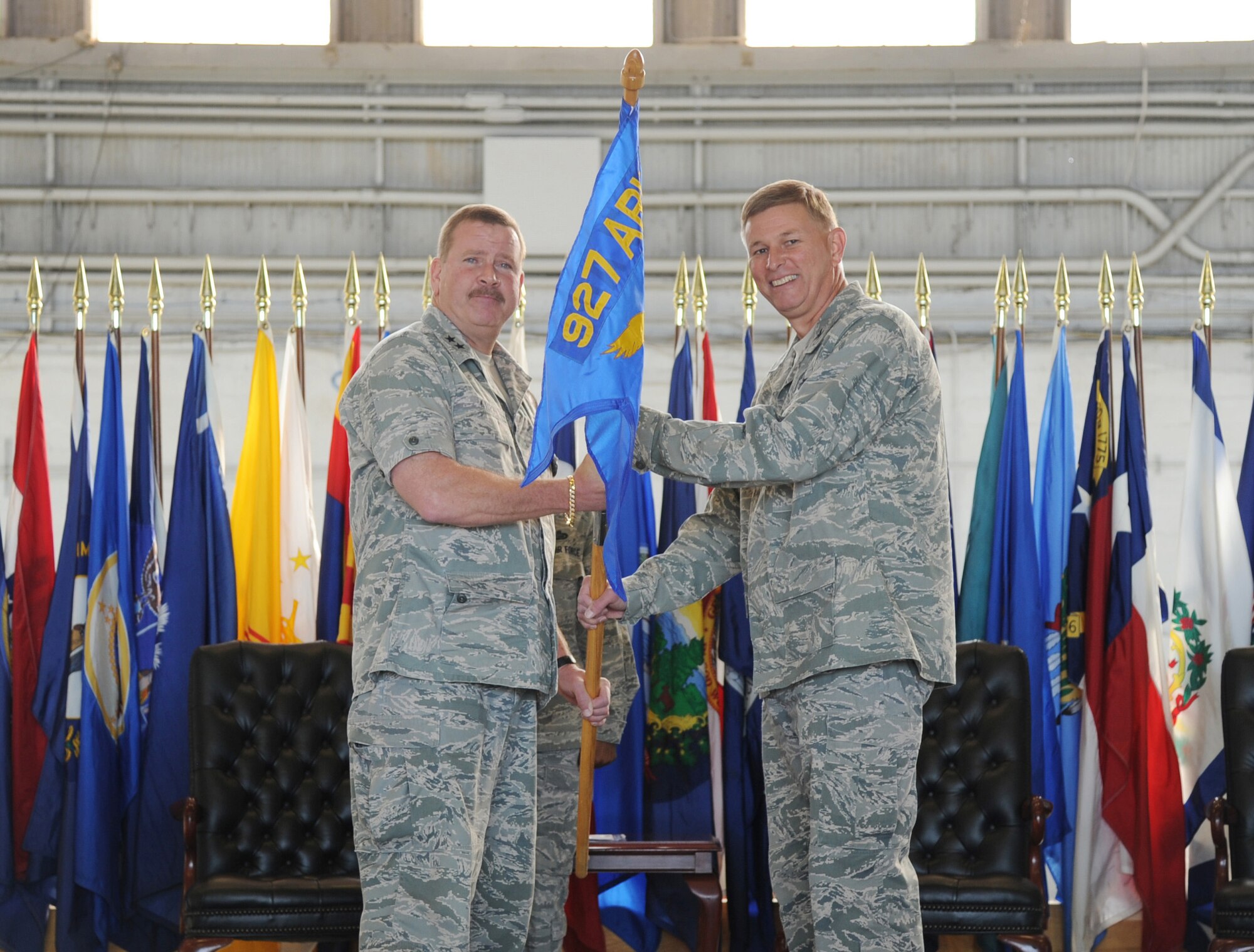 Major General Mark A. Kyle, commander of 4th Air Force, presents the flag to Colonel Douglas J. Schwartz during the Change of Command ceremony at MacDill Air Force Base, Florida, January 12, 2013. The passing of the flag is a traditional military custom signifying the transfer of command, thereby signifying Col. Schwartz's new role as commander of the 927 Air Refueling Wing, a reserve wing of more than 800 members.  