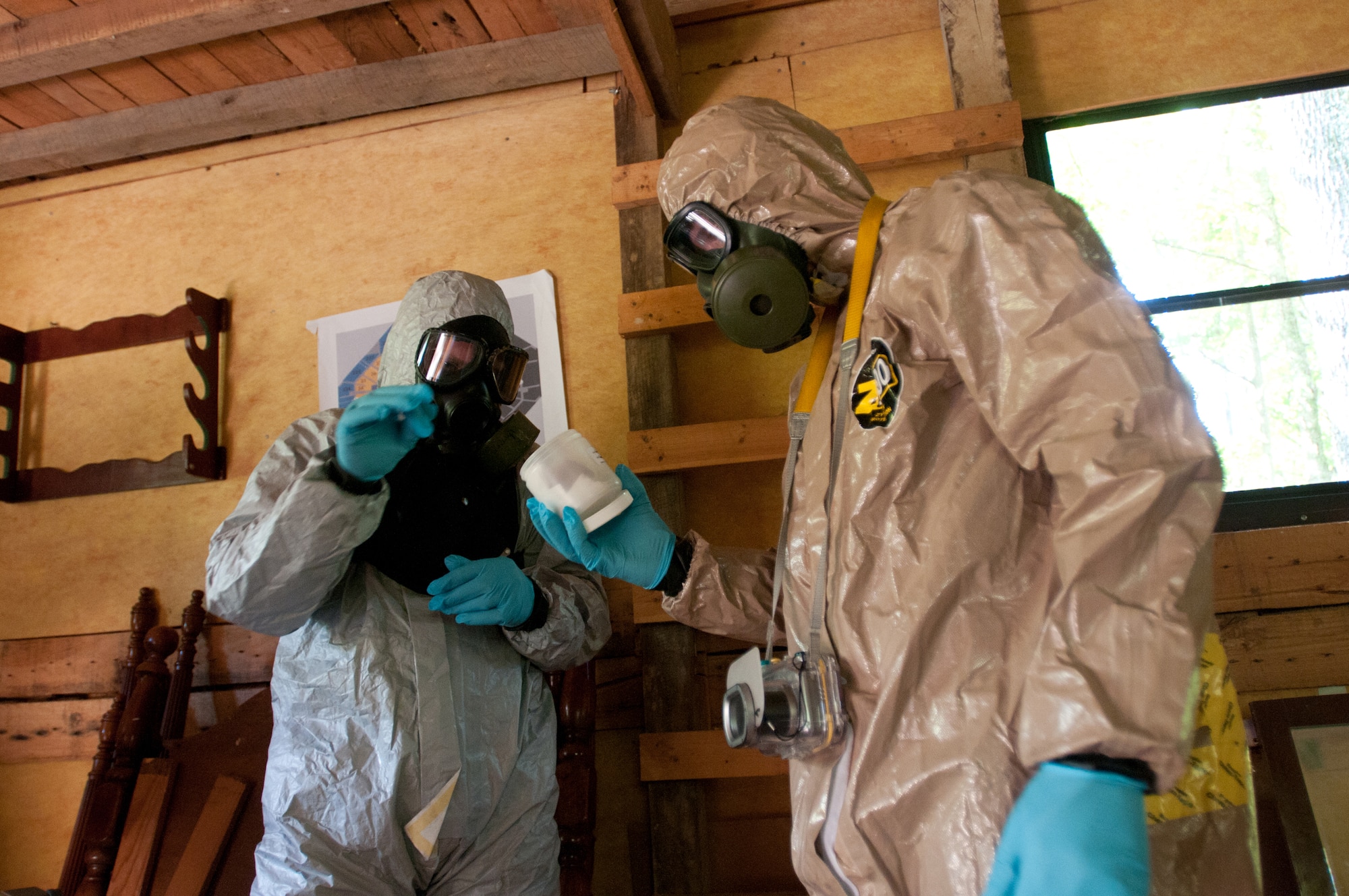 Members of the Kentucky National Guard's 41st Civil Support Team survey a cabin where suspected bomb making substances are present during a U.S. Army North exercise on Oct. 2, 2012, in Frankfort, Ky. (Kentucky Air National Guard photo by Master Sgt. Phil Speck)