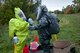 Kentucky Army National Guard Sgt. 1st Class Michael Davis, decontamination NCOIC for the 41st Civil Support Team, conducts decontamination procedures for Kentucky Air National Guard Staff Sgt. Joe Cloutier, a survey team member, as Cloutier returns from operations in the 