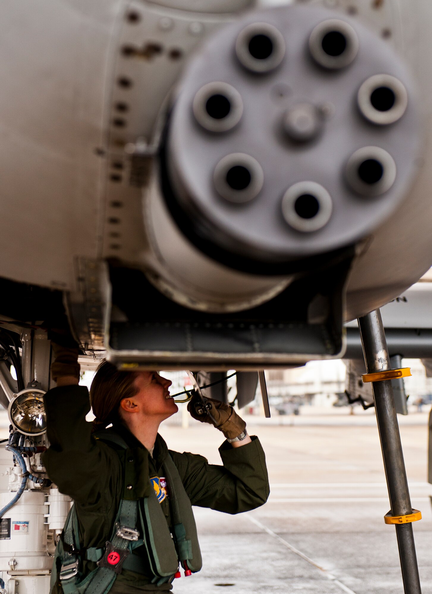 Maj. Olivia Elliott, of the 40th Flight Test Squadron, completes preflight checks of her A-10 Thunderbolt II prior to a test mission Jan. 10 at Eglin Air Force Base, Fla.  Her mission was to wrap up flight testing of the new Net-T software upgrade on the LITENING II advanced targeting pod.  The new upgrade allows the pod to provide ground forces beyond-line-of-sight command and control capabilities as long as the aircraft is within range.  This is the first-ever test of this new capability.   (U.S. Air Force photo/Samuel King Jr.)