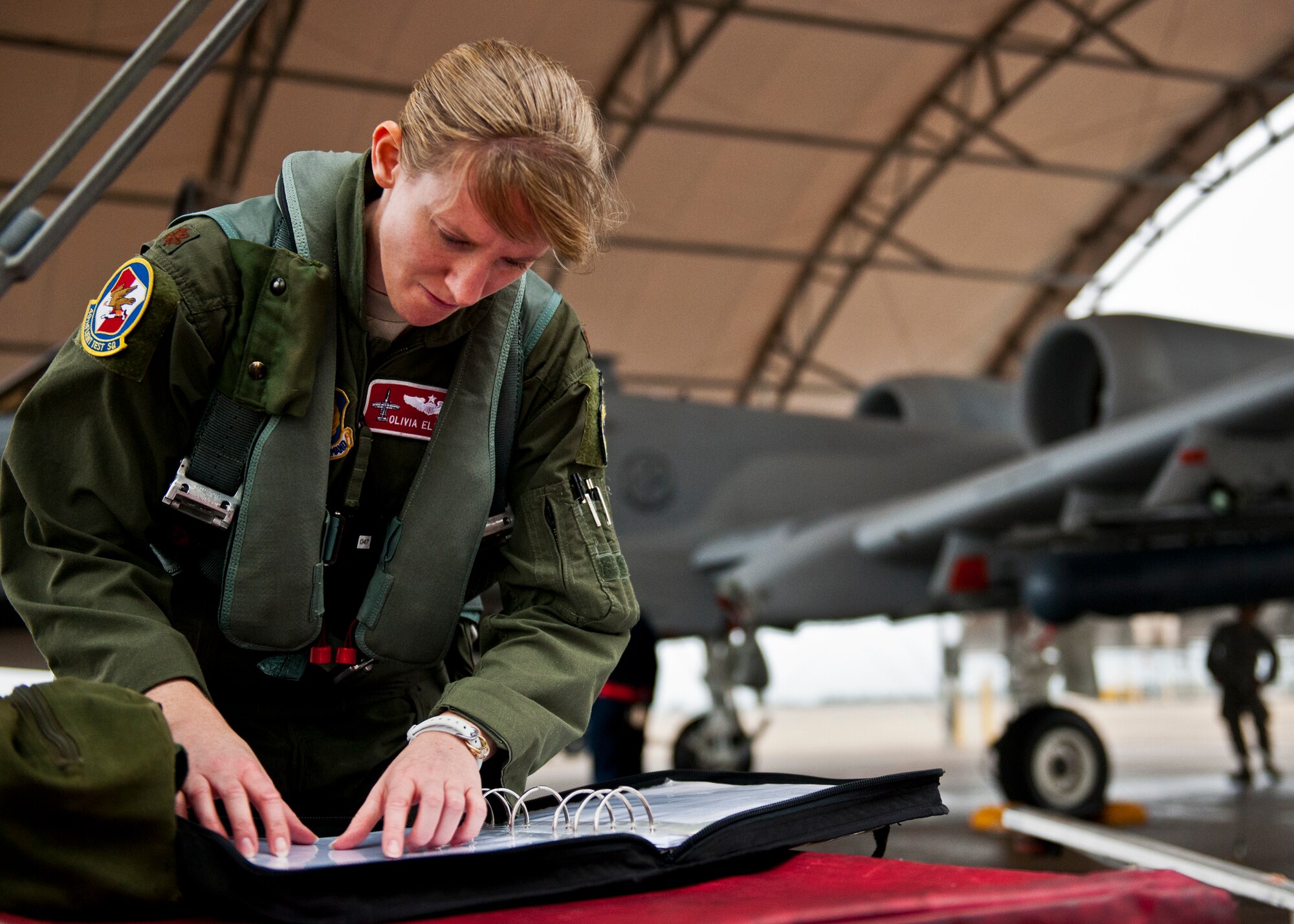 Maj. Olivia Elliott, of the 40th Flight Test Squadron, examines the logbook for her A-10 Thunderbolt II prior to a test mission Jan. 10 at Eglin Air Force Base, Fla.  Her mission was to wrap up flight testing of the new Net-T software upgrade on the LITENING II advanced targeting pod.  The new upgrade allows the pod to provide ground forces beyond-line-of-sight command and control capabilities as long as the aircraft is within range.  This is the first-ever test of this new capability.   (U.S. Air Force photo/Samuel King Jr.)