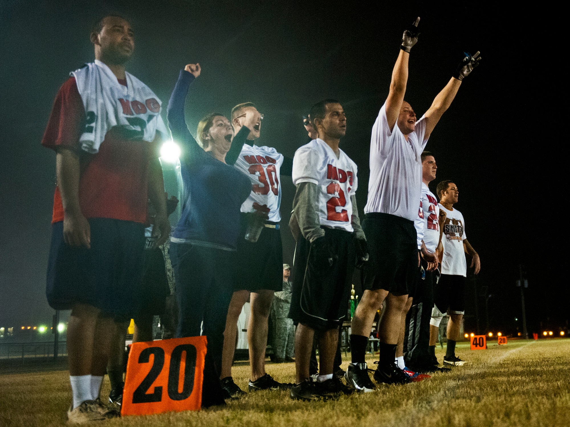 Fans and players with the 96th Medical Group cheer as the base intramural championship game comes to an end with MDG leading 33-16.  Their opponents were the Contracting Team. (U.S. Air Force photo/Samuel King Jr.)