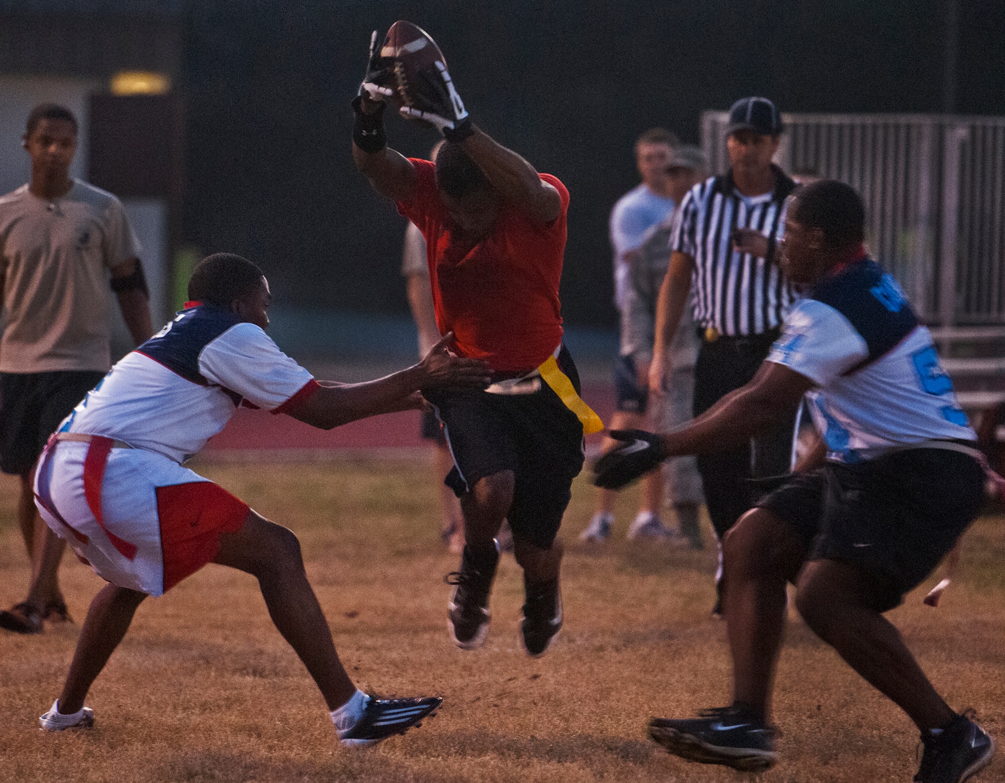 Aaron Nelson, a member of the Contracting Team dives for more yardage against 96th Medical Group defenders during the base intramural championship game Jan. 9 at Eglin Air Force Base, Fla.  The Medical Group won easily 33-16.  (U.S. Air Force photo/Samuel King Jr.