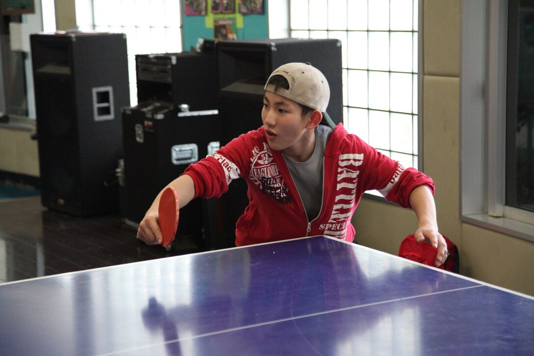Daisuke Chiba prepares to return a serve from his ping pong opponent Jan. 12 during the second annual youth cultural exchange and homestay program. During the four-day program, children from Oshima Island lived with U.S. military volunteer host families and participated in group and individual activities coordinated by their host families.