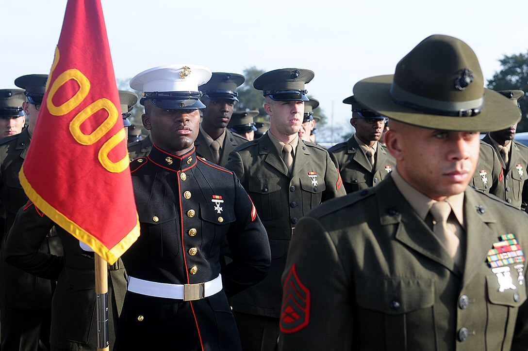 Private First Class Lorenzo Jackson III, of Pembroke Pines, Fla., and honor graduate for platoon 3000, stands behind his chief drill instructor, Staff Sgt. Javier Corcino, before graduation begins aboard Parris Island, S.C., Jan. 11, 2013. Upon graduation, Jackson will spend time with his family while on leave, before heading to Camp Geiger, N.C., where he will start his infantry training. (U.S. Marine Corps photo by Pfc. John-Paul Imbody)