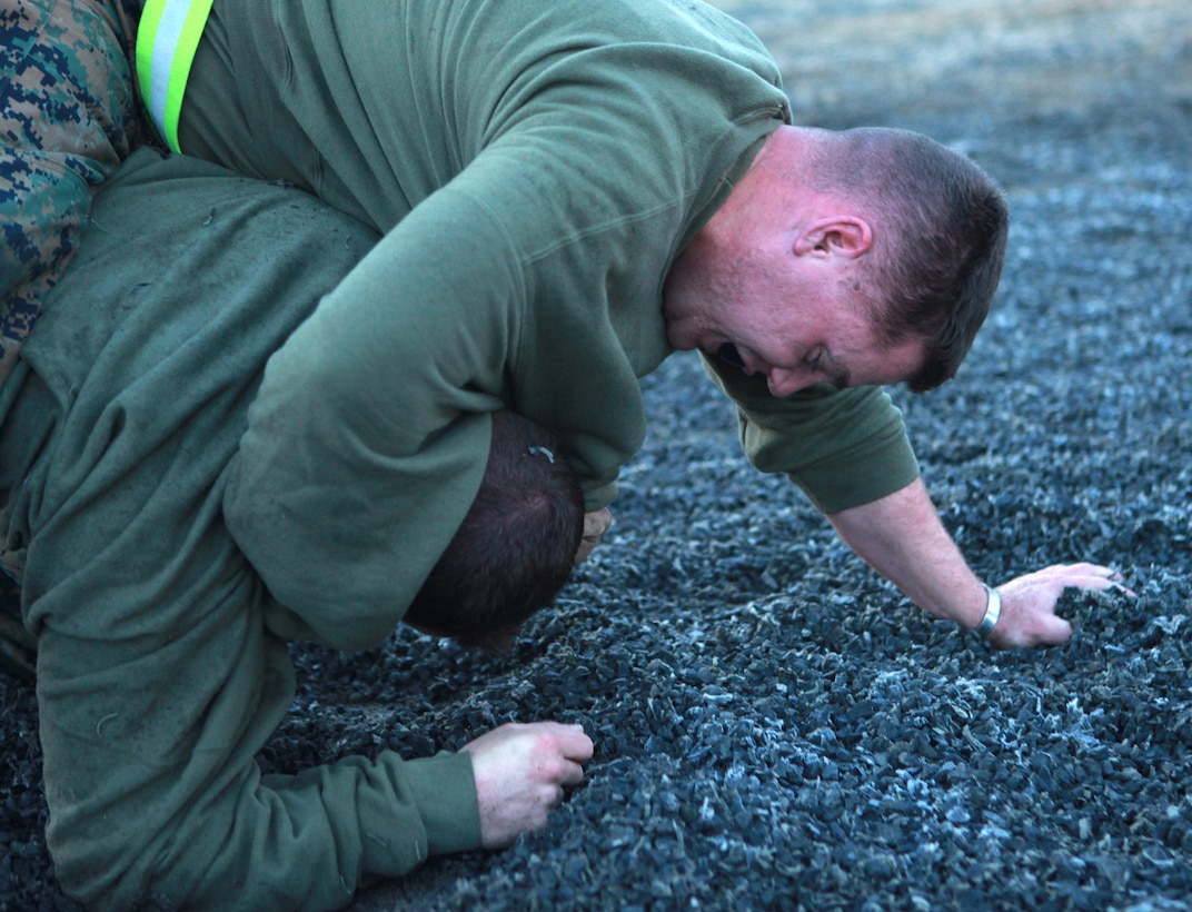 Marines with Bridge Company, 7th Engineer Support Battalion, 1st Marine Logistics Group, grapple during a Marine Corps Martial Arts Program class at Camp Pendleton, Calif., Jan. 11. MCMAP teaches Marines in armed and unarmed hand to hand combat and lessons in warrior ethos.