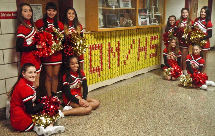 MARINE CORPS BASE QUANTICO, Va. (Jan.10) – Cheerleaders celebrate the reveal of Quantico Middle/High School’s first “CANstruction” project, made entirely of cans, in the school’s lobby on Jan. 7. It took more than 250 cans to complete the project.