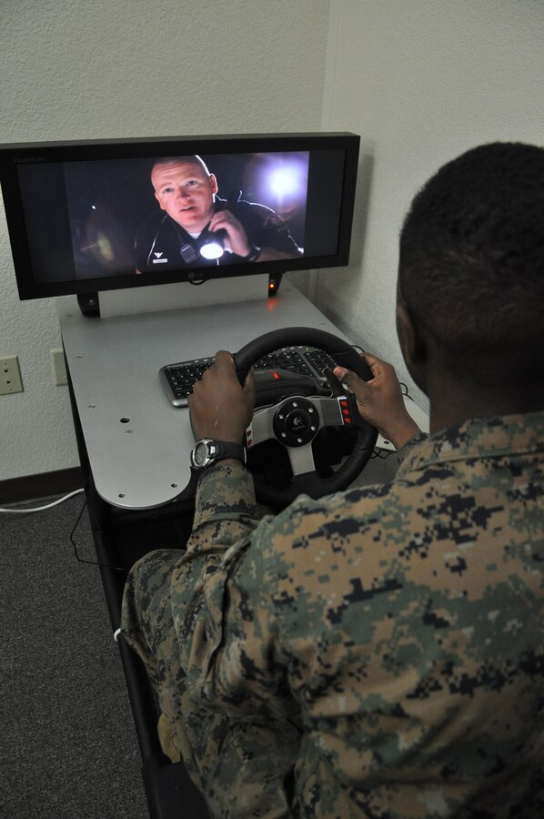 Private First Class Folson Fairley-Baker, a supply clerk aboard Marine Corps Logistics Base Barstow uses a virtual driving simulator offered at Headquarters Battalion's 'back in the saddle training' held January 7 at the Maj. General James L. Day Conference Center aboard the base. During the class, volunteers were given the chance to drive using the program to simulate the effects of driving under the influence or while being distracted.