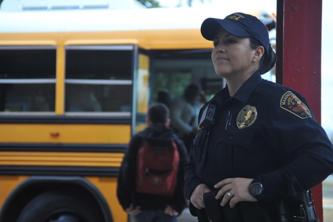 Michelle E. Quick-Reyes, school resource officer, Quantico Middle/High School, assures that the students get aboard the busses safety right after the dismissal bell Jan. 14. Reyes has wanted to be in law enforcement since she was a child. 
