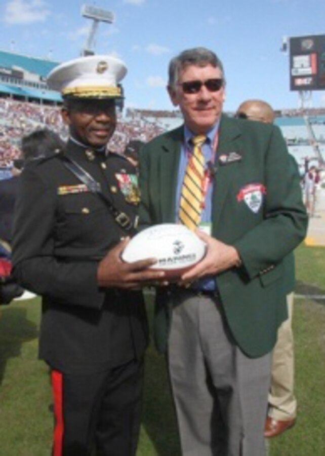 Major General Ronald Bailey, the commanding general of the 1st Marine Division, Camp Pendleton, Calif., gives Rick Catlett, president of the Gator Bowl Association, a Marine Corps Football as an appreciative token for participation opportunity in the 2013 Taxslayer.com Gator Bowl, Jan. 1.