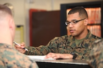 Seaman Marcel L. Buckley, a surgical technician with 2nd Dental Battalion, 2nd Marine Logistics Group, assists a patient with paperwork at the Osborne Dental Clinic aboard Camp Lejeune, N.C., Jan. 14, 2013. Buckley recently received 2nd MLG’s Sailor of the Year award for 2012 after competing against his peers on the unit’s board.