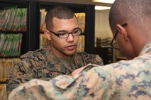 Seaman Marcel L. Buckley, a surgical technician with 2nd Dental Battalion, 2nd Marine Logistics Group, assists a patient checking in for a dental appointment at the Osborne Dental Clinic aboard Camp Lejeune, N.C., Jan. 14, 2013. Buckley claimed the Sailor of the Year title for 2012 after competing against his peers on a board held by the unit. 