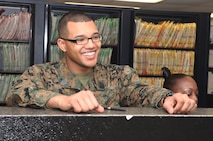 Seaman Marcel L. Buckley, a surgical technician with 2nd Dental Battalion, 2nd Marine Logistics Group, greats patients at the Osborne Dental Clinic aboard Camp Lejeune, N.C., Jan. 14, 2013. Buckley is known for his characteristic smile, which he said reflects the positive attitude he strives to bring to every situation he encounters. 