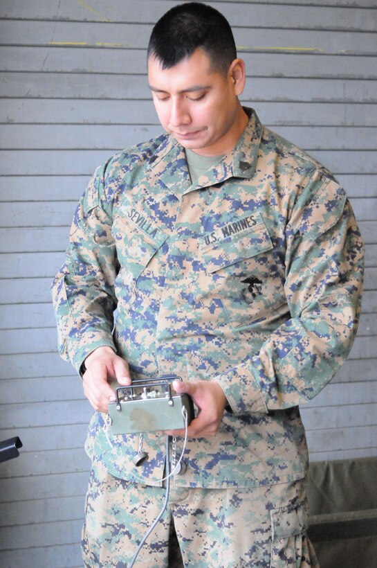 MARINE CORPS BASE QUANTICO, Va. (Jan. 11) – Sgt. Luis Sevila, a warehouse cleck for supply platoon, The Basic School, checks the diagnostics of field tent heaters at TBS supply warehouse. Behind the scenes, Supply platoon is responsible for tracking the beans, bullets and Band-aids for all of The Basic School.