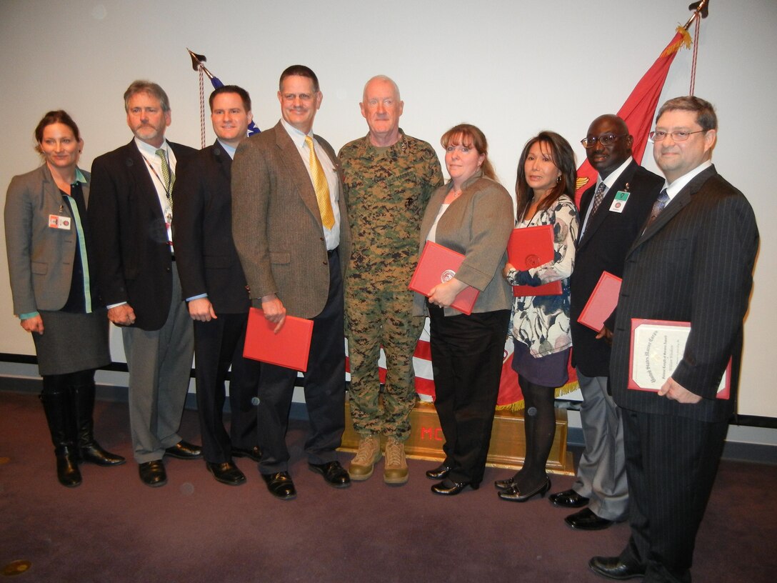 From left are Marine Corps Combat Development Command Civilian of the Quarter Shannon Green, Civilian of the Year first runner-up Kevin Jones, Civilian of the Year second runner-up Robert Grillo, Civilian of the Year Erik Doyle, Commanding General Lt. Gen. Richard Mills, and civilian length of service honorees Jill Glando, Sonia Vraa, Laroy Mitchell and William Woodson. 