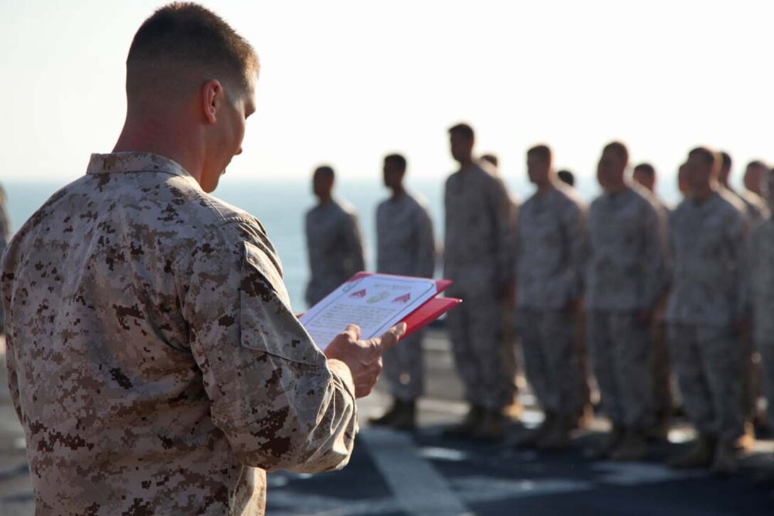Corporal Kyle C. Sieradzki, artillery cannoneer, 2nd Platoon, Battery B, Battalion Landing Team 3/5, 15th Marine Expeditionary Unit, reads the Non-Commissioned Officerâ€™s Creed after receiving his new rank aboard the USS Rushmore, Dec. 24. The 15th MEU is deployed as part of the Peleliu Amphibious Ready Group as a U.S. Central Command theater reserve force, providing support for maritime security operations and theater security cooperation efforts in the U.S. 5th Fleet area of responsibility. (U.S. Marine Corps photo by Cpl. Timothy R. Childers)