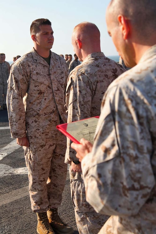 Corporal Kyle C. Sieradzki, artillery cannoneer, 2nd Platoon, Battery B, Battalion Landing Team 3/5, 15th Marine Expeditionary Unit, receives his new rank aboard USS Rushmore, Dec. 24. The 15th MEU is deployed as part of the Peleliu Amphibious Ready Group as a U.S. Central Command theater reserve force, providing support for maritime security operations and theater security cooperation efforts in the U.S. 5th Fleet area of responsibility. (U.S. Marine Corps photo by Cpl. Timothy R. Childers/Released)