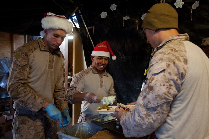 U.S. Marines and Sailors assigned Fox Company, 2nd Battalion, 7th Marine Regiment (Fox, 2/7), enjoy Christmas dinner on Forward Operating Base Now Zad, Helmand province, Afghanistan, Dec. 25, 2012. The Marines of Fox, 2/7 deployed to Afghanistan in support of Operation Enduring Freedom. (U.S. Marine Corps photo by Cpl. Alejandro Pena/Released)