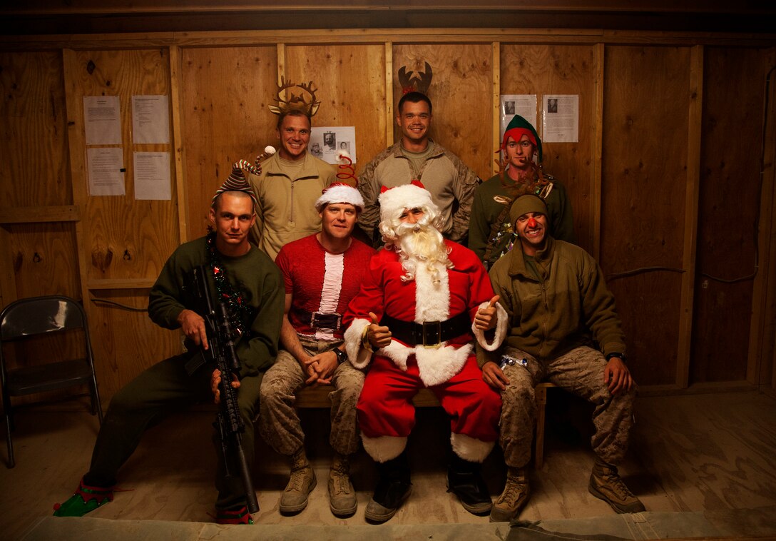 U.S. Marines assigned to Afghan National Civil Order Police Advisory Team, 2nd Battalion, 7th Marine Regiment (2/7), bring some holiday cheer to their fellow Marines on Forward Operating Base Now Zad, Helmand province, Afghanistan, Dec. 24, 2012. The Marines of 2/7 deployed to Afghanistan in support of Operation Enduring Freedom. (U.S. Marine Corps photo by Cpl. Alejandro Pena/Released)    