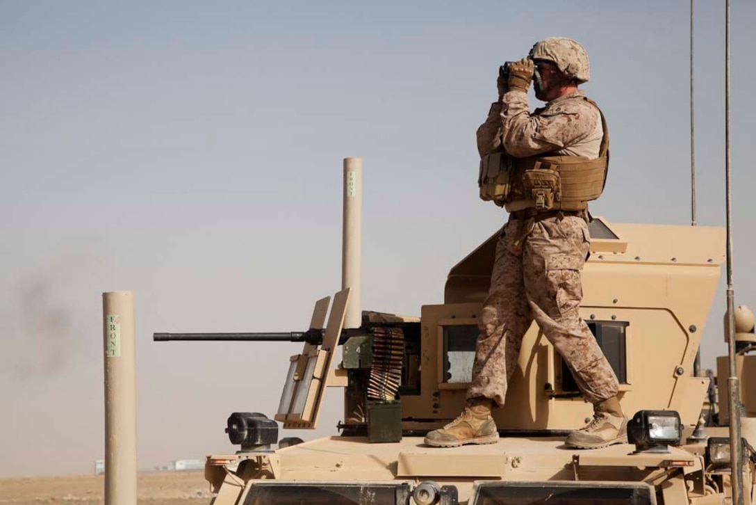 U.S. Marine Corps Gunnery Sgt. Steed M. Flint, the senior enlisted advisor for Police Advisory Team 5, 2nd Battalion, 7th Marine Regiment (2/7), observes distant targets while conducting live fire training near Combat Outpost Now Zad, Helmand province, Afghanistan, Dec. 29, 2012. Flint, originally from Idaho Falls, Idaho deployed to Afghanistan with 2/7 in support of Operation Enduring Freedom.  (U.S. Marine Corps photo by Cpl. Alejandro Pena/Released)