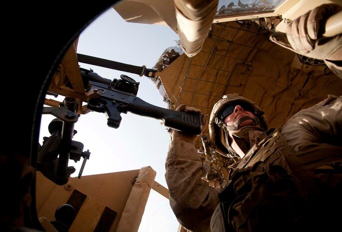 U.S. Marine Corps Cpl. J.A. Carlson, a machine gunner assigned to combined anti-armor team, Fox Company, 2nd Battalion, 7th Marine Regiment (Fox 2/7), provides security prior to conducting live fire training near Combat Outpost Now Zad, Helmand province, Afghanistan, Dec. 29, 2012. The Marines of Fox 2/7 conducted live fire training to maintain operational readiness and proficiency. (U.S. Marine Corps photo by Cpl. Alejandro Pena/Released)