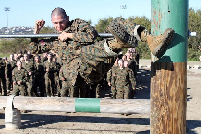 A recruit of Company C, 1st Recruit Training Battalion, struggles to climb over the first bar during the obstacle course aboard Marine Corps Recruit Depot San Diego Jan. 3. Recruits learn about their strengths and weaknesses as they push themselves through each obstacle. 