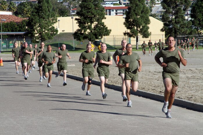 Recruits of Company H, 2nd Recruit Training Battalion, push themselves through the last stretch of their timed three-mile run during the final physical fitness test aboard Marine Corps Recruit Depot San Diego Dec. 27. The final PFT tests recruit's strength and endurance. The score they receive at recruit training will follow them to their first duty station. 